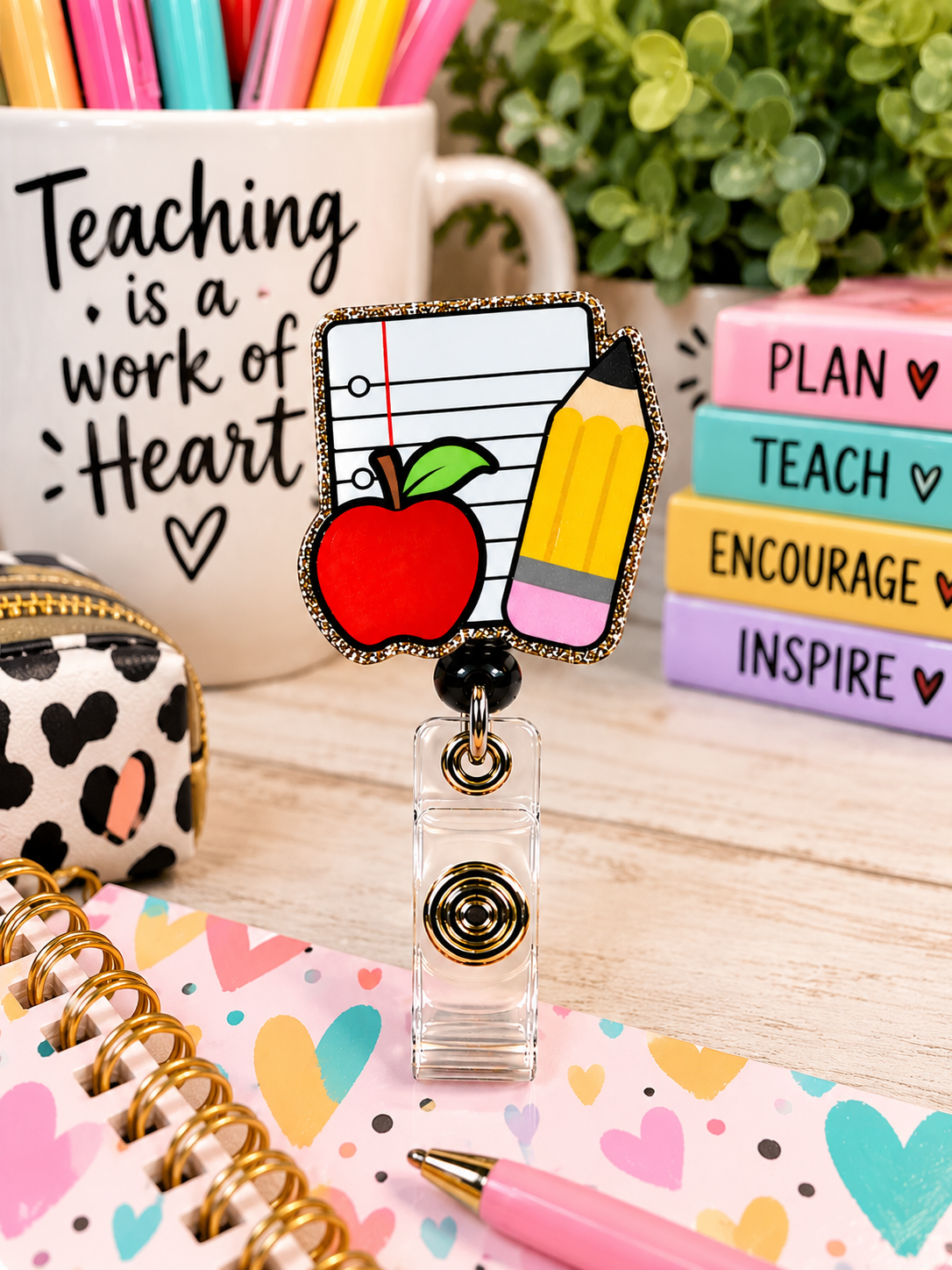 Apple and pencil teacher badge reel framed by colorful school-themed illustrations