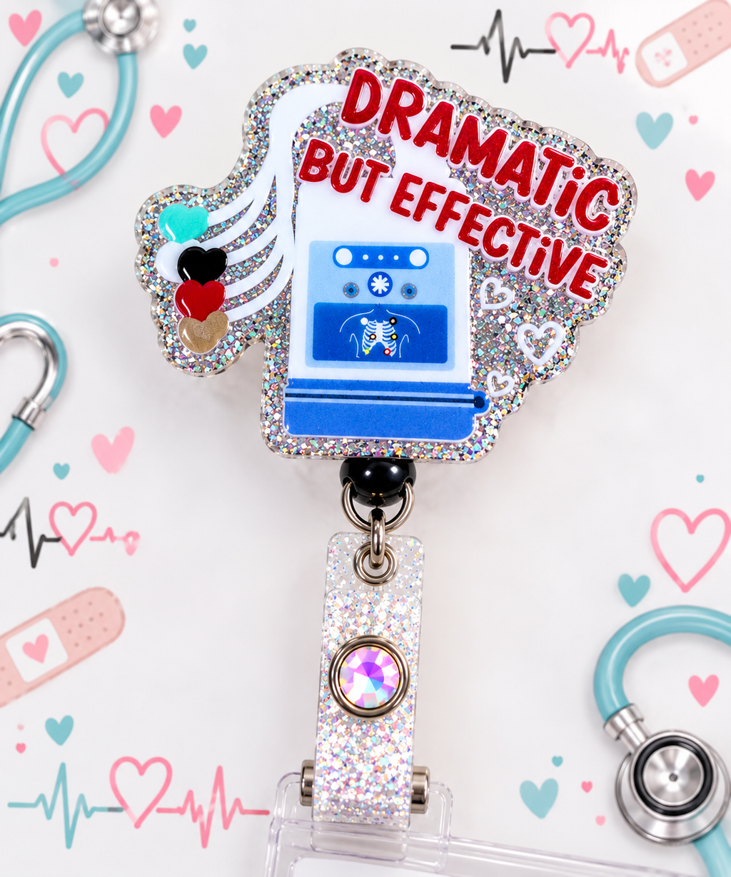 Dramatic But Effective badge reel with blue defibrillator artwork and silver glitter