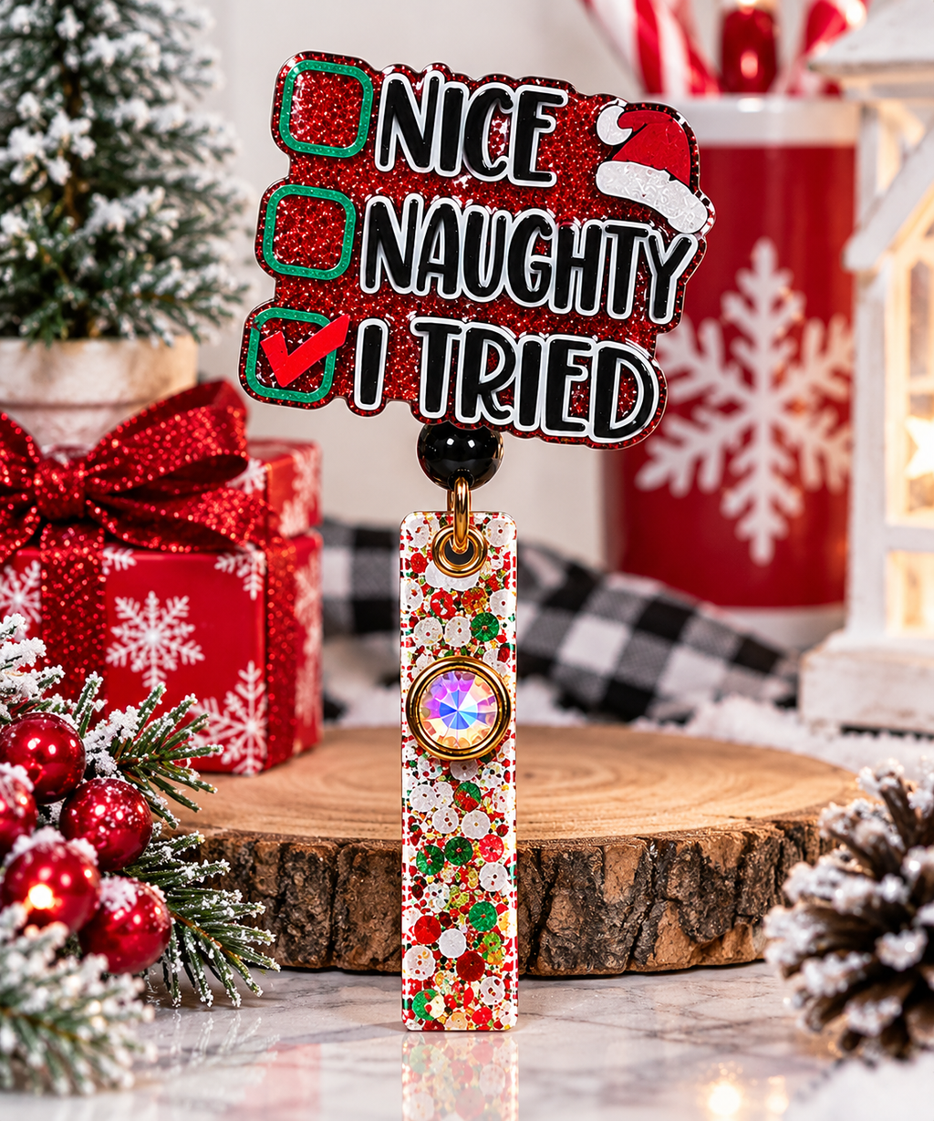 Festive Nice Naughty I Tried badge reel displayed beside Christmas gifts and snowy greenery