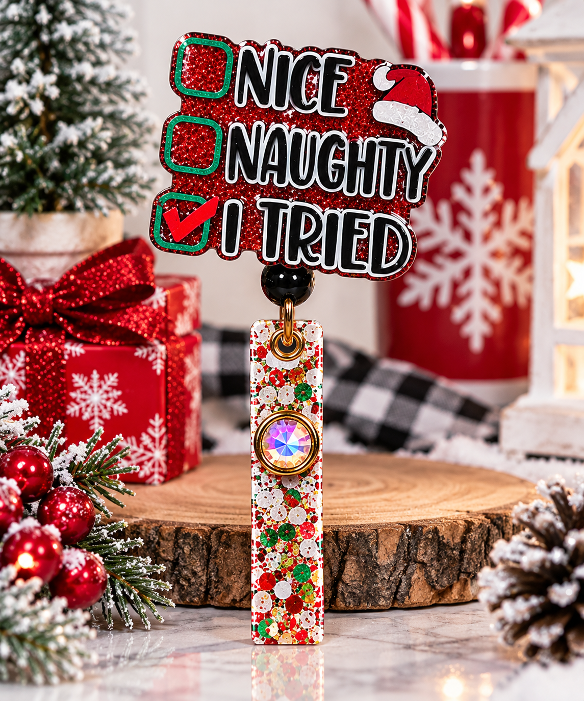 Festive Nice Naughty I Tried badge reel displayed beside Christmas gifts and snowy greenery