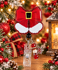 Red glitter Santa bow badge reel with white trim artwork and snowflake charm
