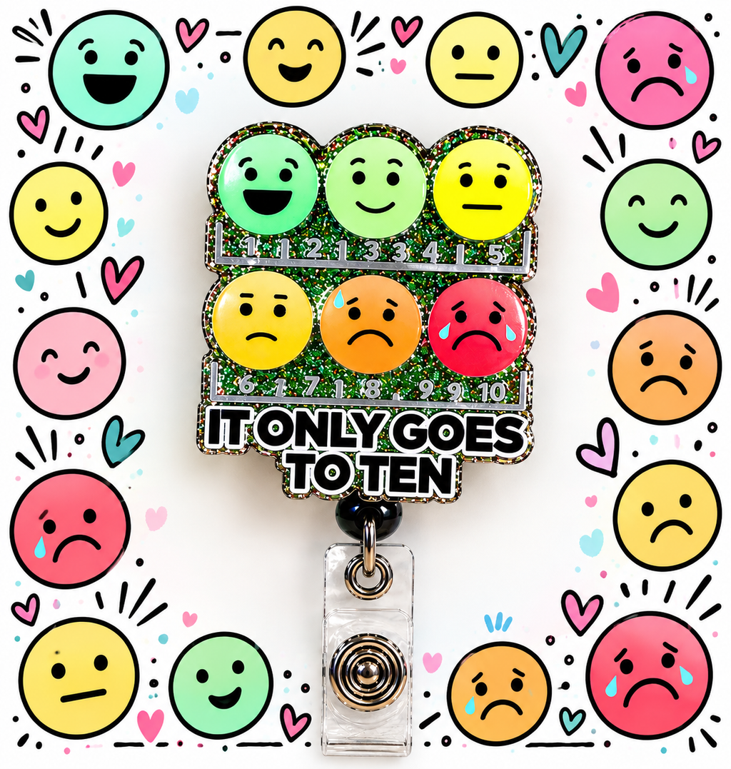 Glitter emoji pain scale badge reel in a colorful healthcare-themed desk display