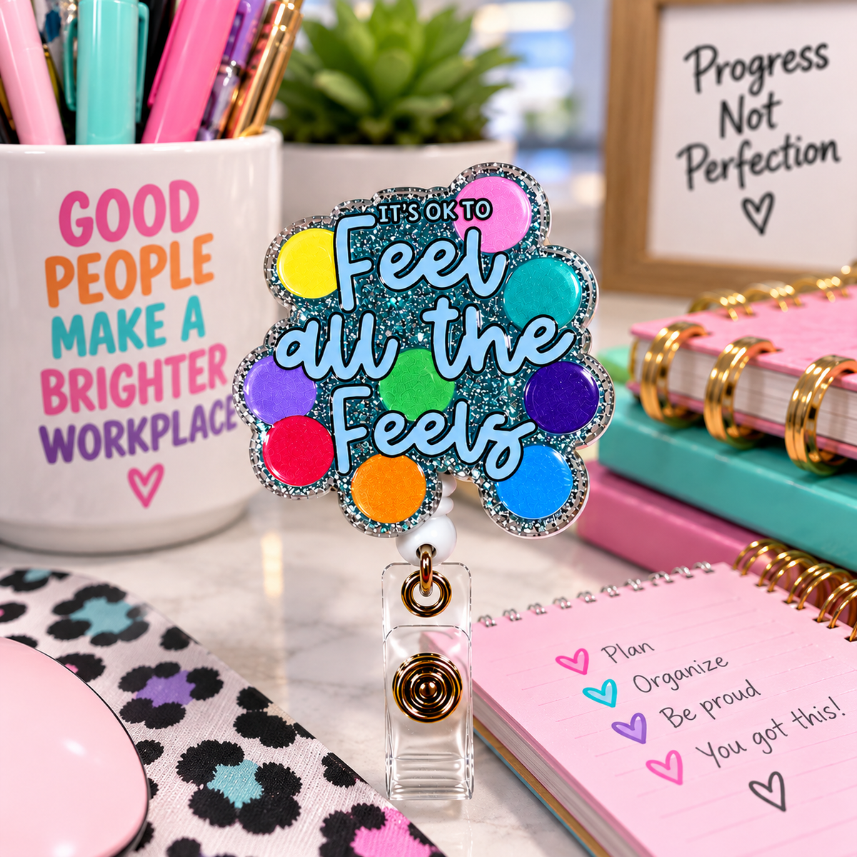 It's OK to Feel All the Feels glitter badge reel surrounded by colorful emoji artwork