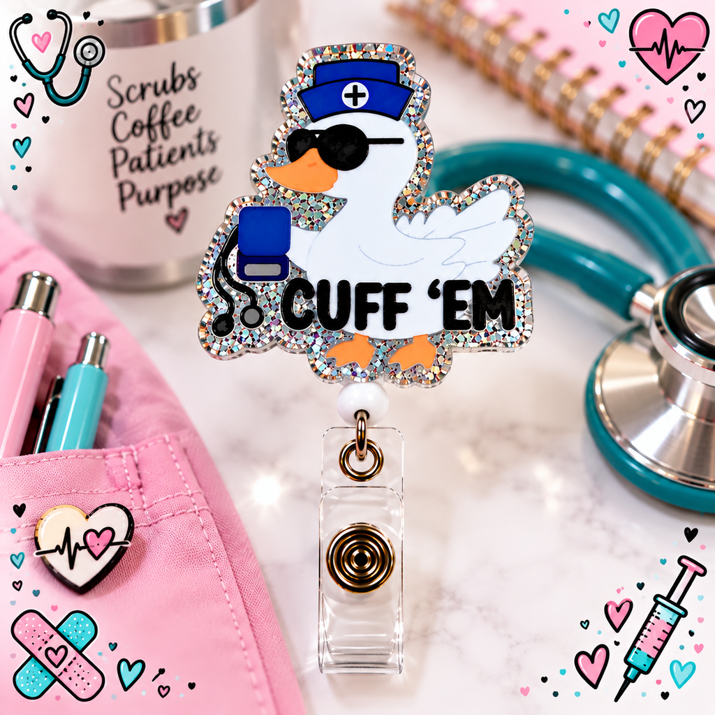 Close-up of Cuff 'Em nurse duck badge reel beside a stethoscope and pink notebook