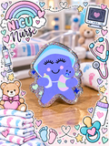 Purple NICU nurse character with blue cap holding a baby and bottle, edged in silver-toned sparkle