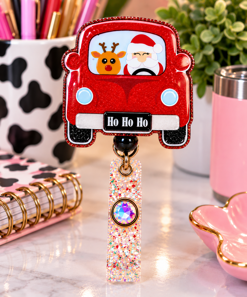Red glitter Christmas car badge reel with Santa, reindeer, and Ho Ho Ho license plate