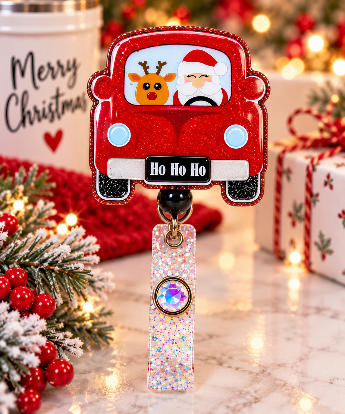 Santa and reindeer Christmas car badge reel with iridescent glitter strap in a festive display