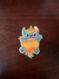 Stitch pumpkin glitter acrylic badge reel on a dark wood background