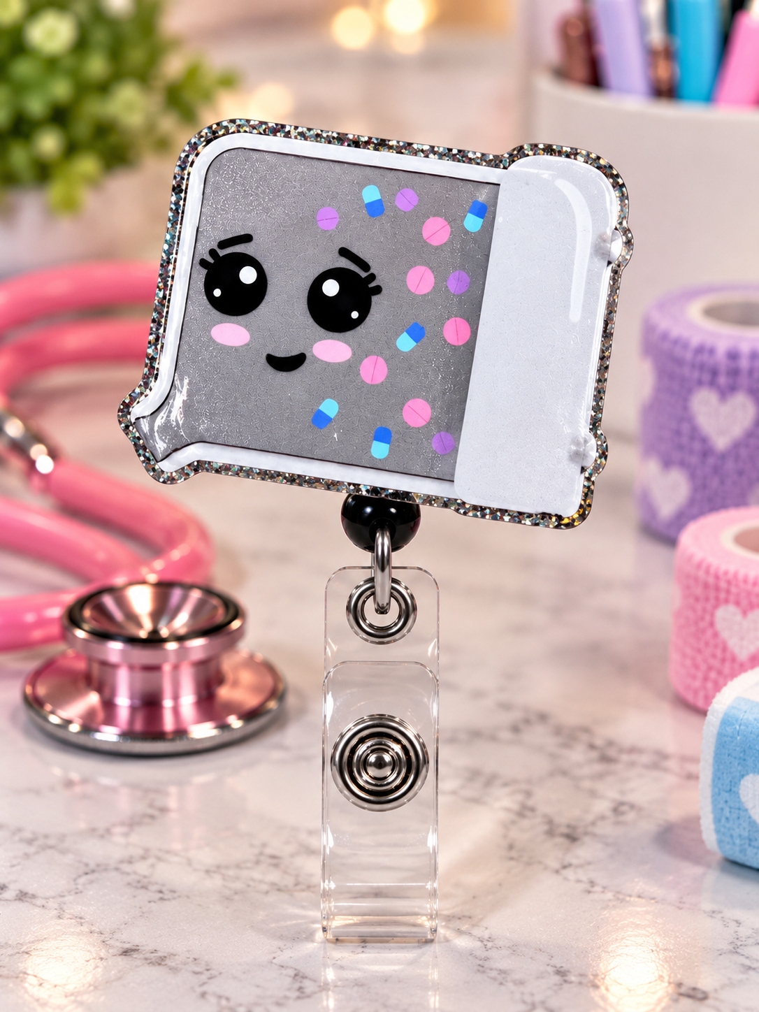 Close-up of glitter-edged pharmacy pill tray badge reel on a marble surface
