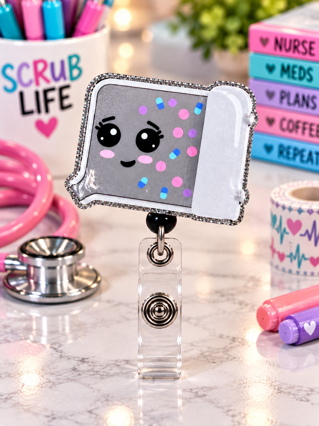 Gray pill-counting tray character badge reel with pink cheeks in a healthcare desk display