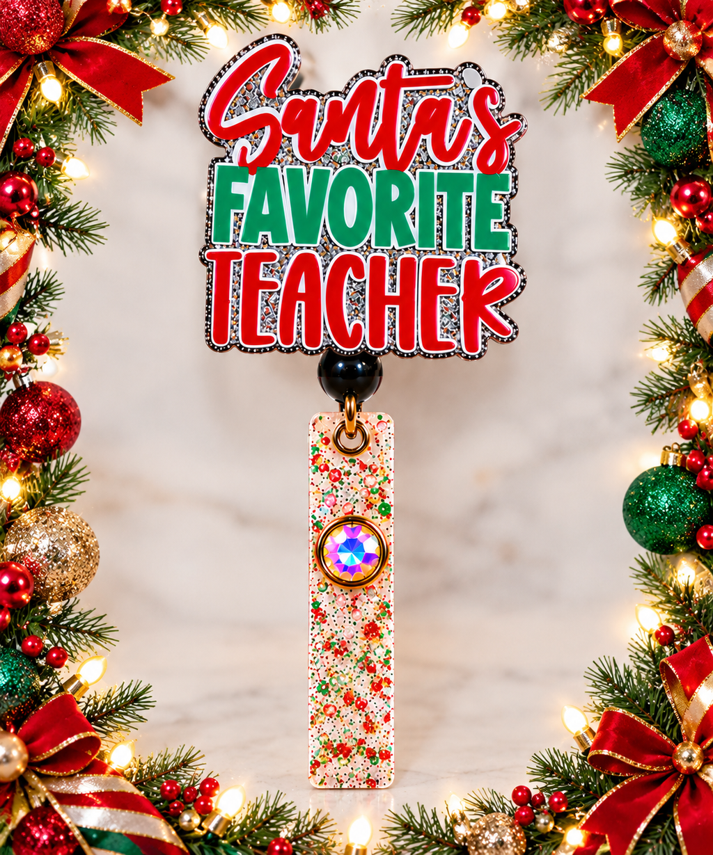 Silver glitter Santa's Favorite Teacher badge reel framed by Christmas greenery and ornaments