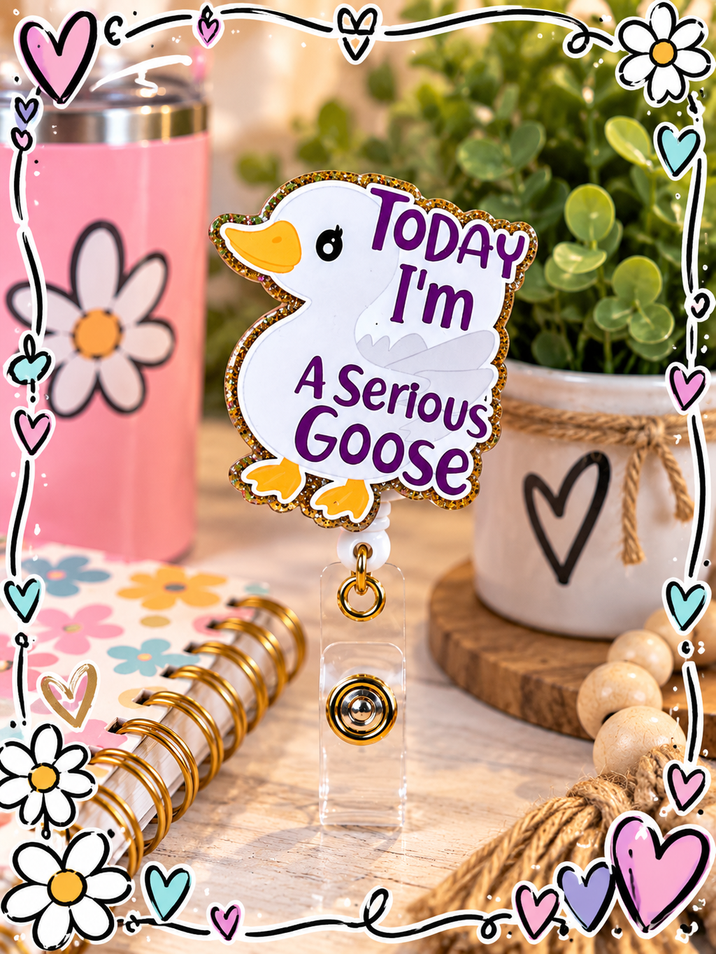 Serious Goose badge reel displayed with pastel desk accessories