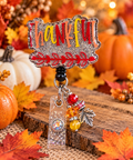 Thankful glitter badge reel with autumn lettering and dangling leaf charm